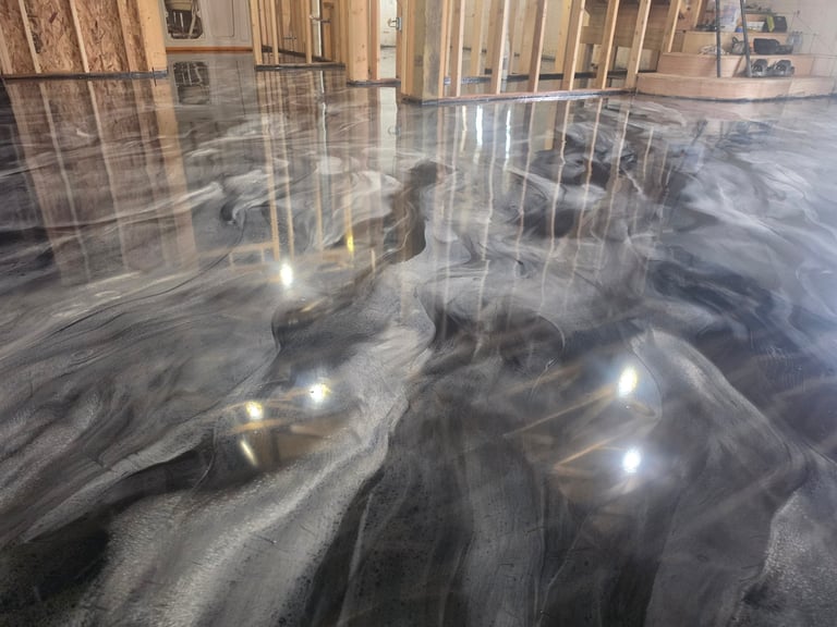 Large sculptural horses with flowing manes displayed indoors on a polished concrete floor with wooden framing visible in background