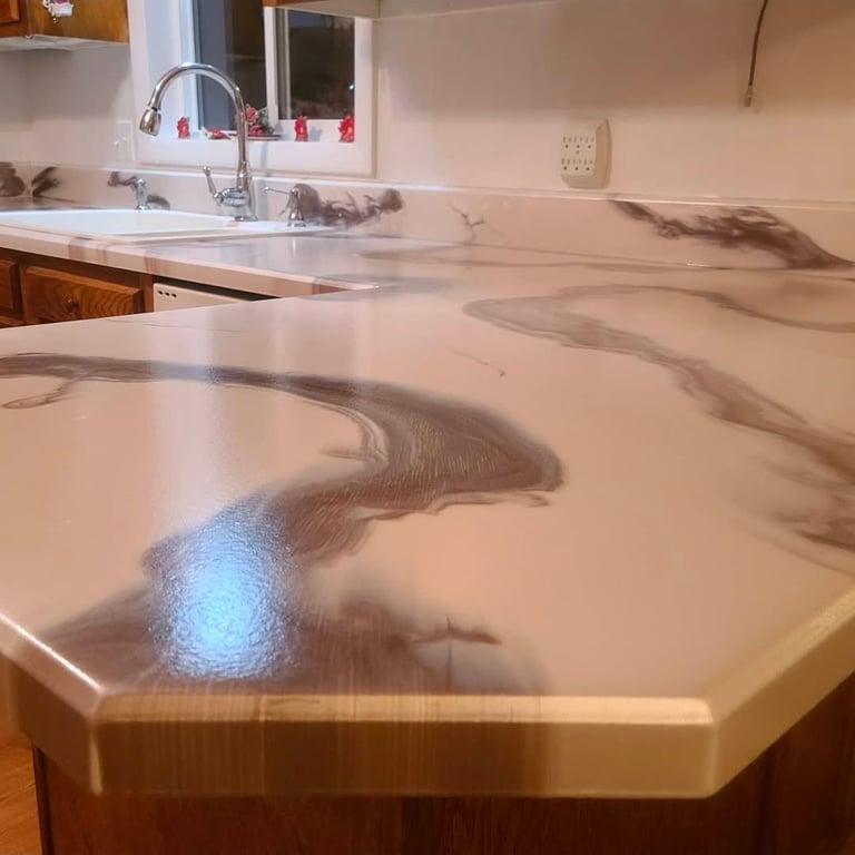 Modern kitchen with white quartz countertop featuring gray veining, chrome faucet, and wooden cabinetry