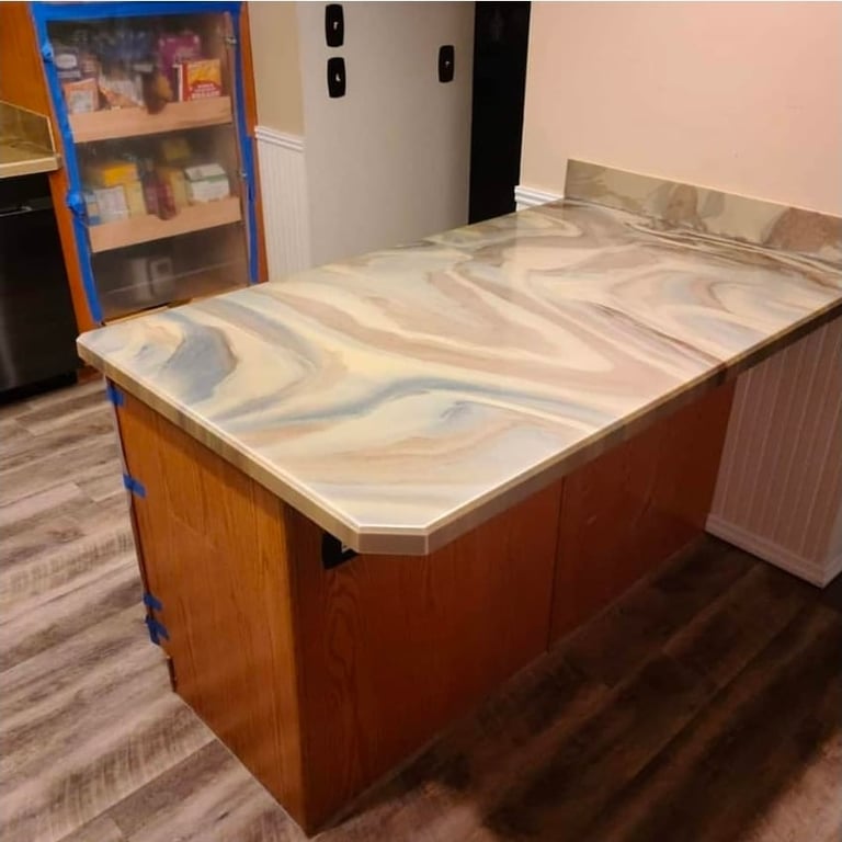 Large wooden kitchen island with white and gray veined marble countertop in a modern kitchen setting