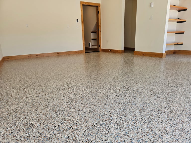 Empty room with polished concrete floor, white walls, wooden door frame, and shelving on right side