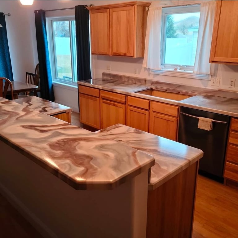 Modern kitchen with wood cabinets, large center island with marble countertop, and windows overlooking outdoor landscape