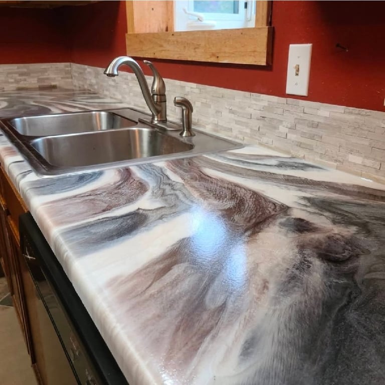 Modern kitchen countertop with marble-look quartz surface, dual stainless steel sink, and faucet with white subway tile backsplash