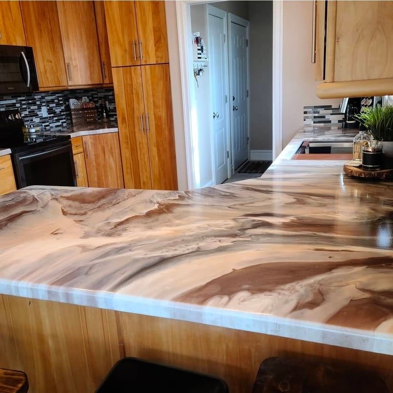 Modern kitchen with wood cabinets, dramatic swirled stone countertops, black appliances, and blue pantry door in background