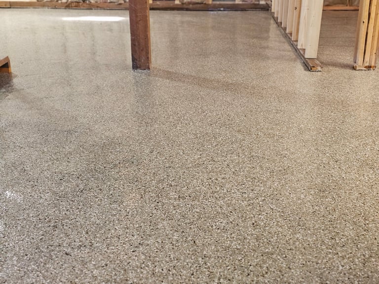 Empty concrete basement floor with wooden support beam and white door frame